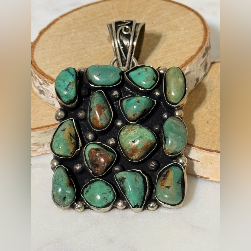 Turquoise cluster pendant set in Tibetan Silver. 14 nuggets, 2”x2”
